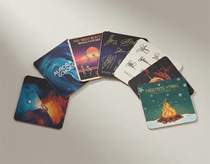 Fan-style display of collectible band coasters featuring album artwork, tour designs, and seasonal themed graphics.
