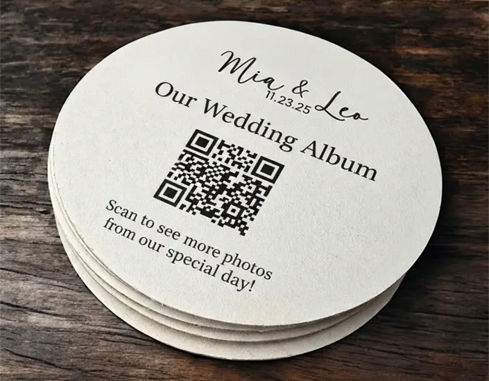 Personalized wedding coasters with names, date, and QR code linking to the couple's wedding photo album.